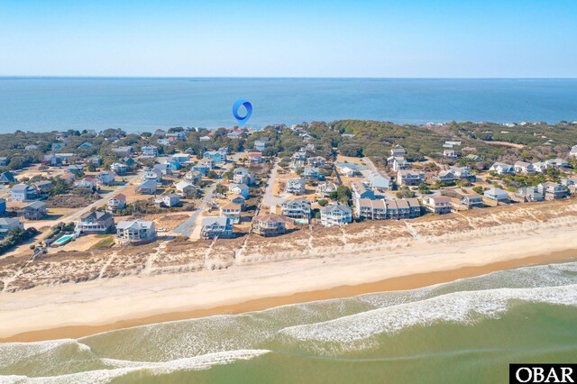 birds eye view of property featuring a water view, a residential view, and a view of the beach