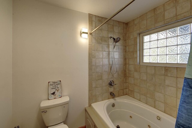 bathroom featuring a combined bath / shower with jetted tub and toilet