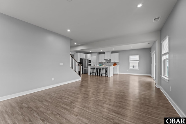 307 Sunny Lk Lot 106, Moyock, NC 27958 - unfurnished living room featuring stairs, dark wood-type flooring, and recessed lighting