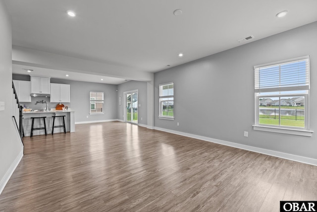 307 Sunny Lk Lot 106, Moyock, NC 27958 - unfurnished living room with wood finished floors and recessed lighting