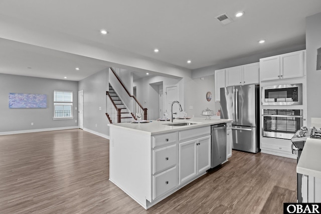 307 Sunny Lk Lot 106, Moyock, NC 27958 - kitchen featuring appliances with stainless steel finishes, wood finished floors, white cabinetry, recessed lighting, and a kitchen island with sink