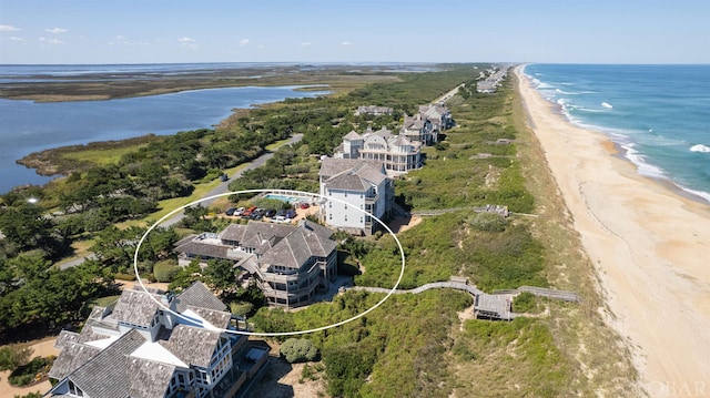 aerial view with a water view, a residential view, and a view of the beach