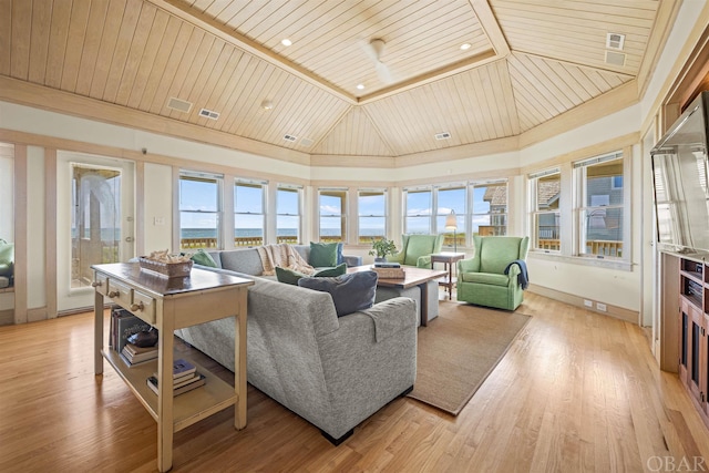 living room with vaulted ceiling, a healthy amount of sunlight, wood ceiling, and light wood-style floors