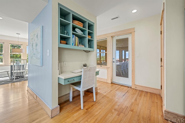 office space featuring baseboards, light wood-type flooring, visible vents, and recessed lighting