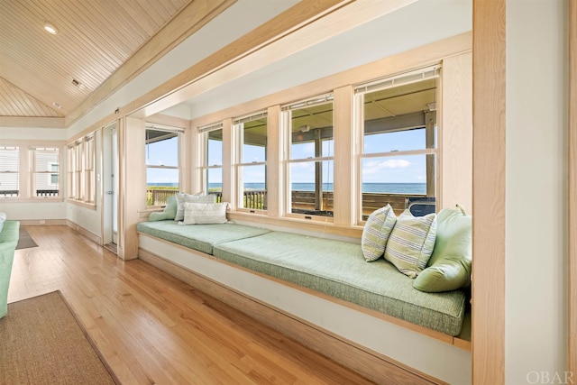 bedroom featuring baseboards, lofted ceiling, wood ceiling, wood finished floors, and a water view