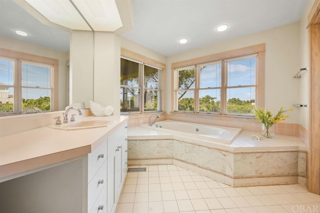 full bathroom with a garden tub, a wealth of natural light, and vanity