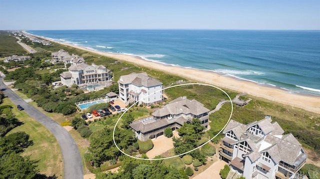 aerial view featuring a beach view, a residential view, and a water view