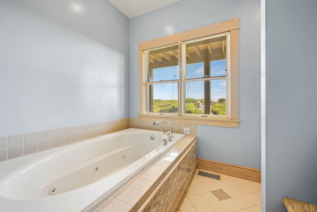 bathroom with visible vents, a jetted tub, baseboards, and tile patterned floors