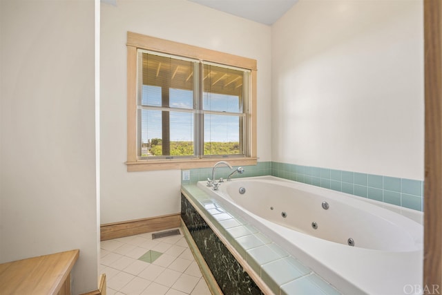 full bath with tile patterned flooring, visible vents, a jetted tub, and baseboards