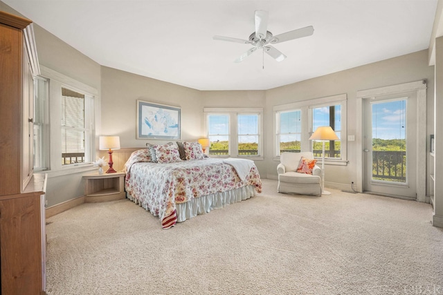 bedroom featuring access to outside, light carpet, ceiling fan, and baseboards