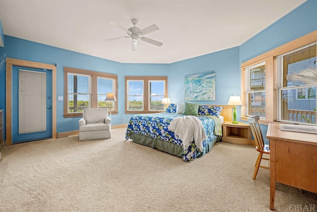 carpeted bedroom with ceiling fan and baseboards