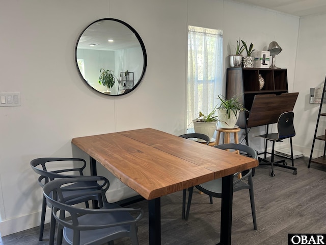 dining area with wood finished floors and baseboards