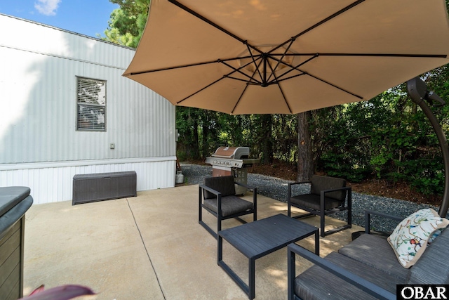 view of patio with area for grilling and an outdoor hangout area