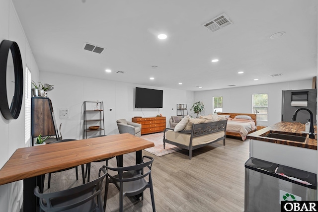 interior space with light wood-style flooring, visible vents, and recessed lighting