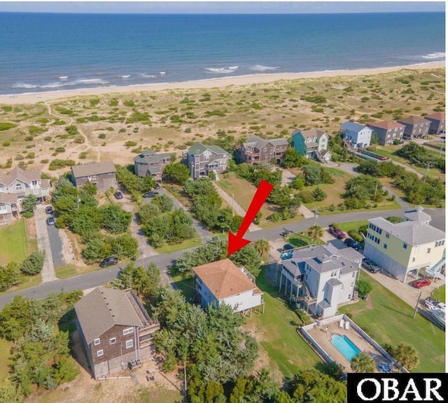 drone / aerial view with a water view, a residential view, and a view of the beach