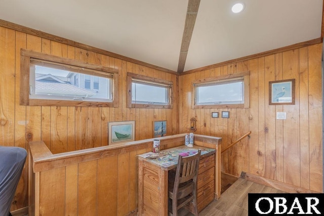 office featuring vaulted ceiling, light wood finished floors, and wooden walls