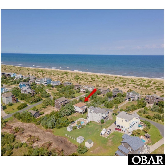 bird's eye view with a water view, a residential view, and a beach view