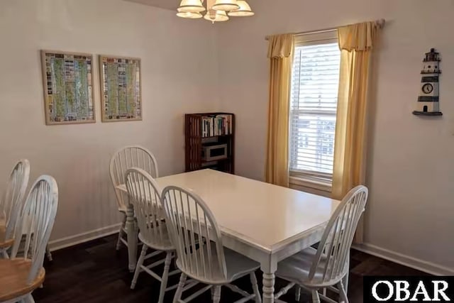 703 Suffolk St Lot 934, Kill Devil Hills, NC 27948 - dining area with healthy amount of natural light, a chandelier, baseboards, and dark wood-style flooring