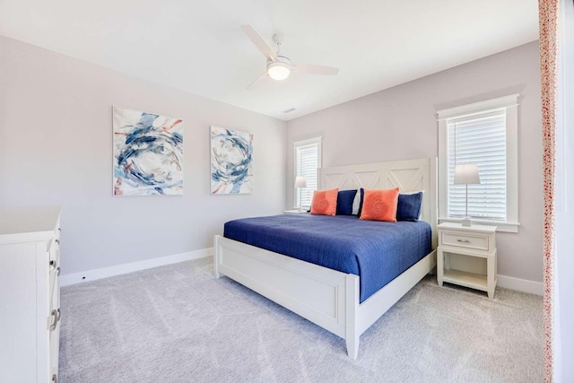 bedroom featuring light carpet, ceiling fan, and baseboards