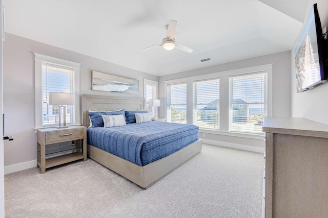 bedroom featuring baseboards, ceiling fan, visible vents, and light colored carpet