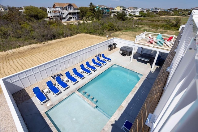 community pool featuring a patio area and a fenced backyard