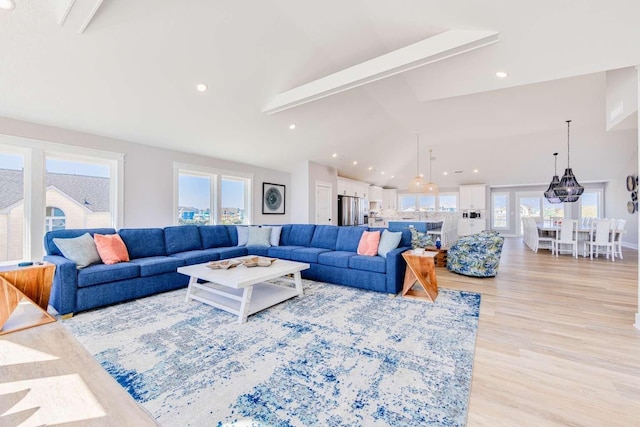 living room with high vaulted ceiling, recessed lighting, beamed ceiling, and light wood-style flooring