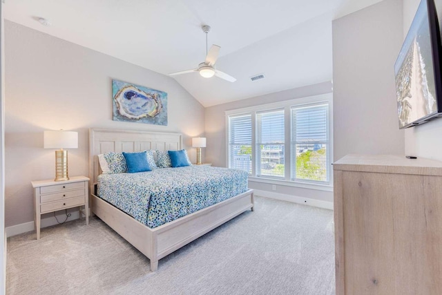 bedroom with light carpet, baseboards, and lofted ceiling