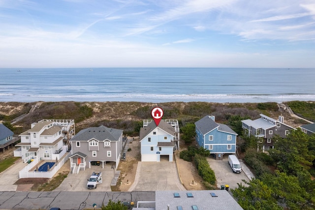 birds eye view of property with a view of the beach, a residential view, and a water view