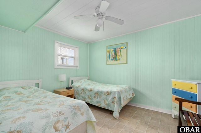 tiled bedroom with ceiling fan, baseboards, and crown molding