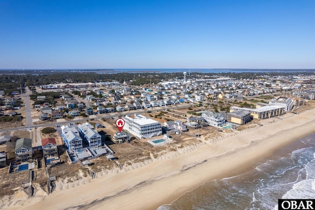 bird's eye view featuring a view of the beach and a water view