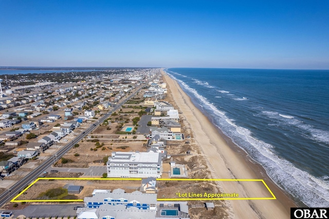 birds eye view of property with a beach view and a water view