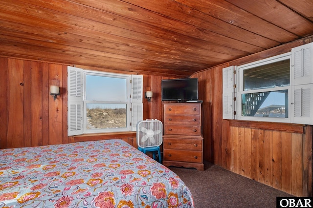 bedroom with carpet floors, wooden ceiling, and wooden walls