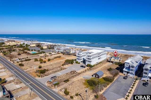 drone / aerial view with a water view and a beach view