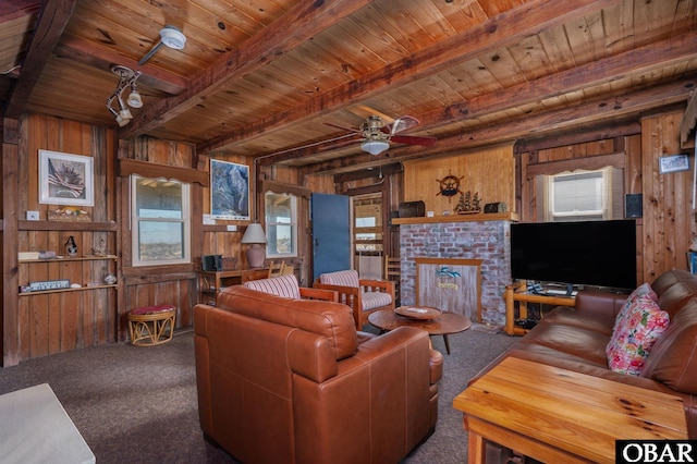 living room with beam ceiling and wooden walls