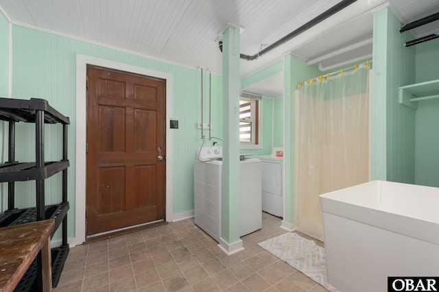 clothes washing area with laundry area, a sink, and washer and dryer