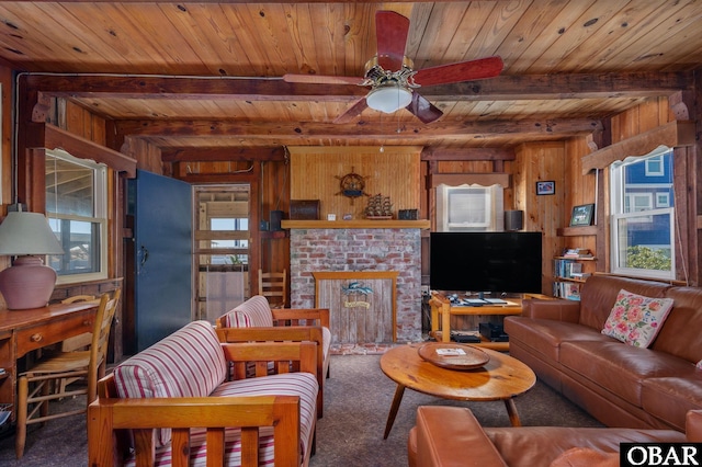 living area featuring wood walls, wood ceiling, a brick fireplace, beamed ceiling, and carpet