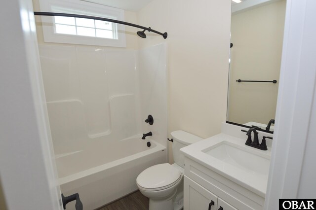 bathroom featuring wood finished floors, vanity, toilet, and bathing tub / shower combination