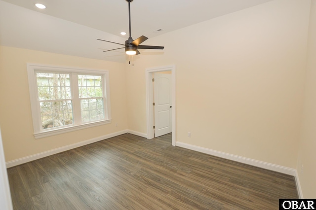 empty room with visible vents, baseboards, dark wood-style flooring, and recessed lighting