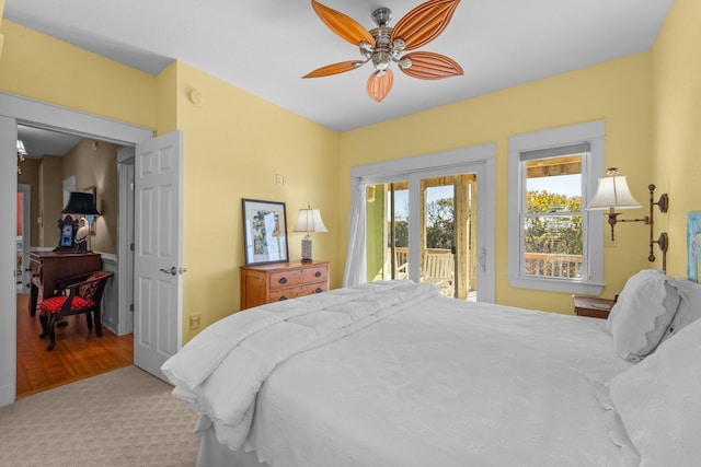 carpeted bedroom with access to exterior and a ceiling fan