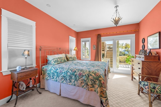 bedroom with baseboards, access to outside, and light colored carpet