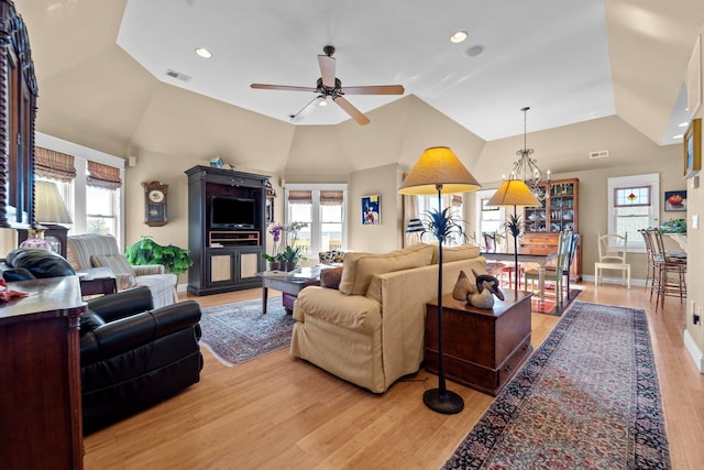 living area with vaulted ceiling, recessed lighting, visible vents, and light wood-style floors