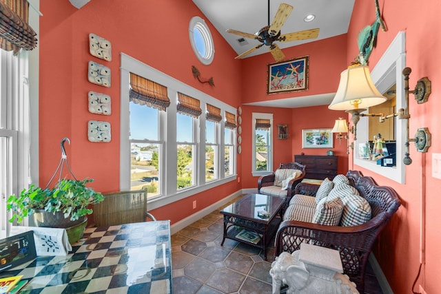 sunroom / solarium featuring a ceiling fan