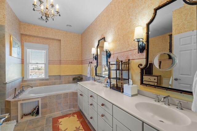 bathroom featuring double vanity, a sink, a bath, and wallpapered walls