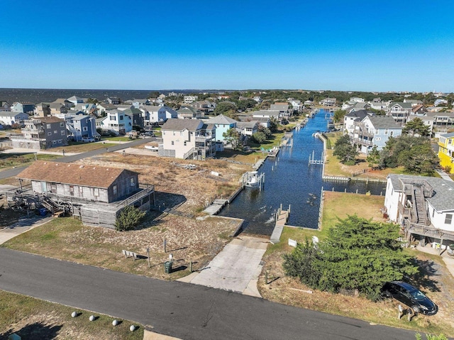 bird's eye view featuring a water view and a residential view