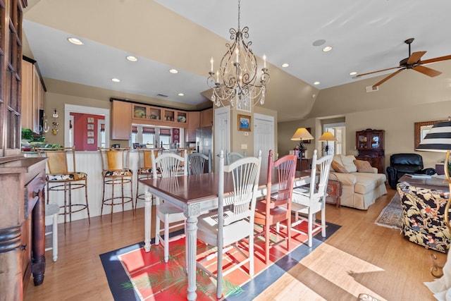 dining room featuring light wood-style flooring, visible vents, vaulted ceiling, and recessed lighting