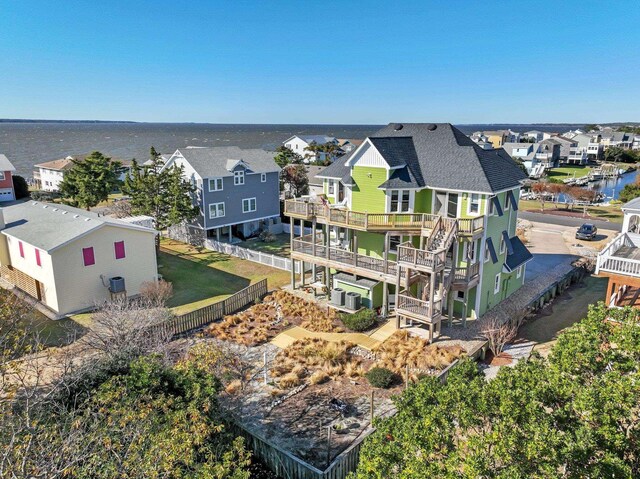 drone / aerial view with a residential view and a water view