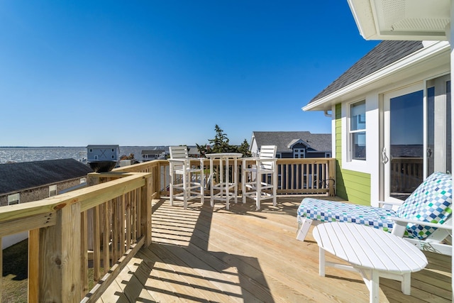 wooden deck featuring a water view