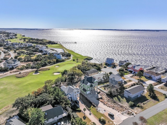 aerial view with a residential view, view of golf course, and a water view