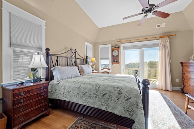 bedroom featuring vaulted ceiling, access to outside, light wood-style flooring, and visible vents