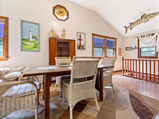 dining space with vaulted ceiling and baseboards